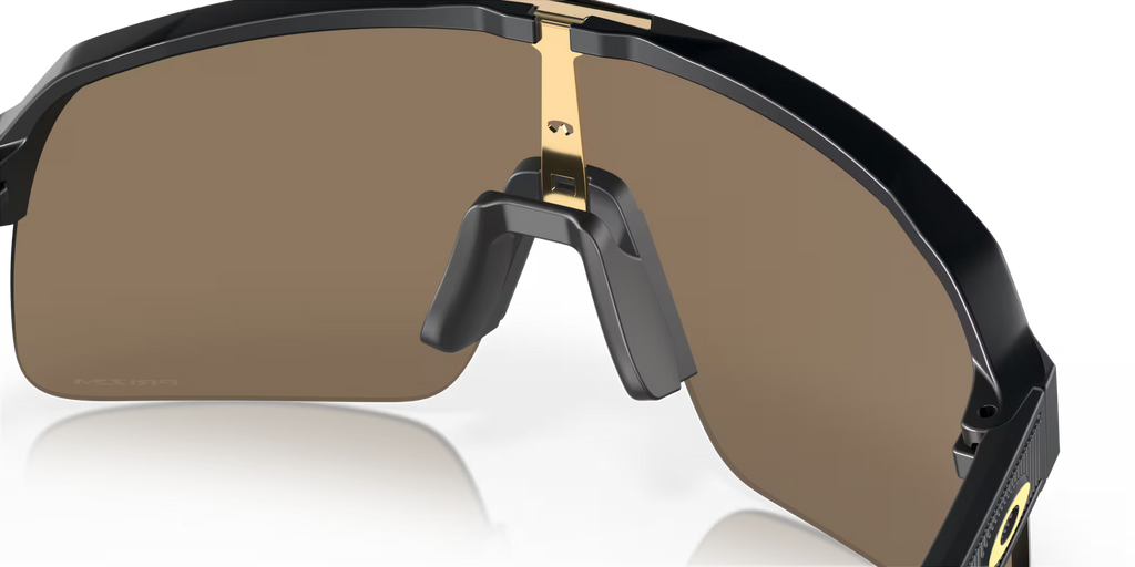 Oakley Sutro Lite Matte Carbon Prizm 24K sunglasses, three-quarter interior view showing the carbon-grey frame and nose pads.