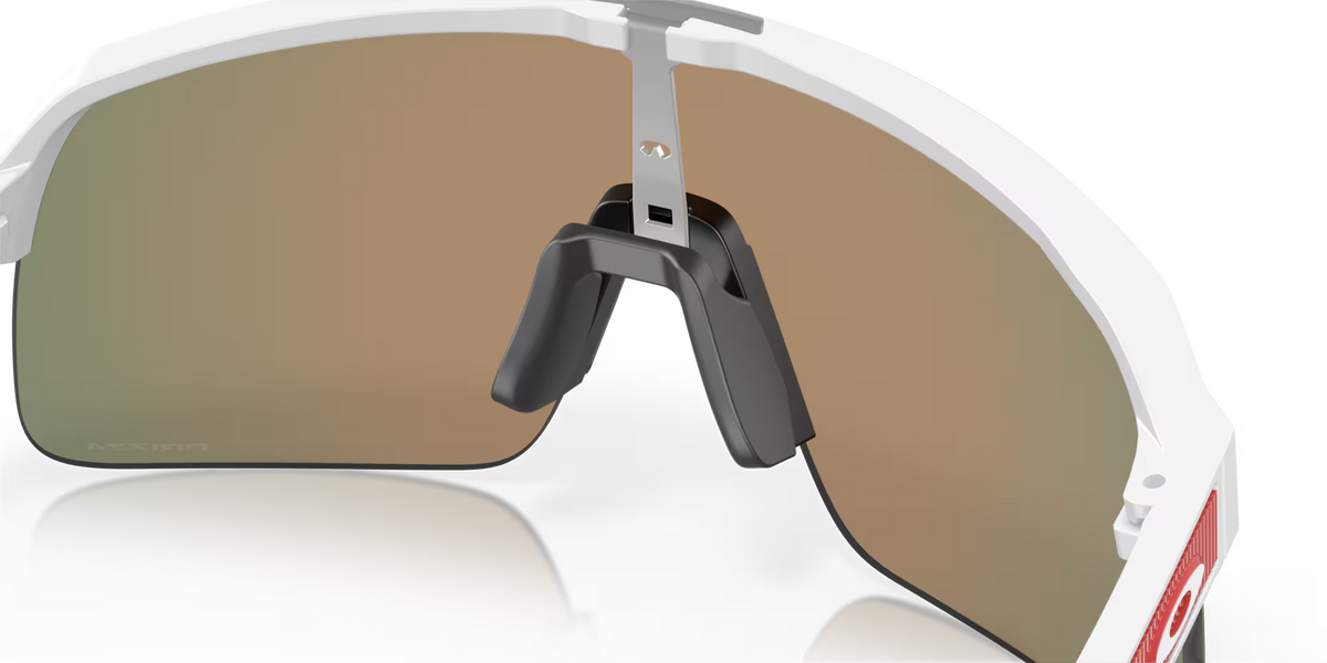 Oakley Sutro Lite S sunglasses in Matte White with Prizm Ruby lenses, three-quarter interior view showing the frame and nose pads.