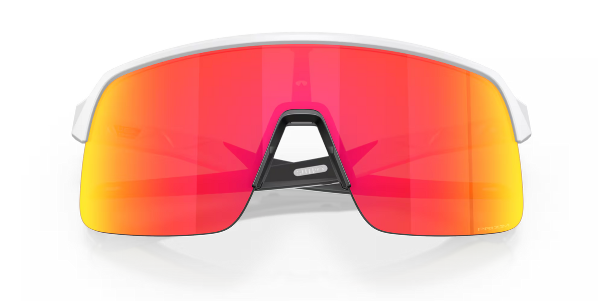 Oakley Sutro Lite S Matte White Prizm Ruby sport sunglasses, front view with crossed white temples visible through the red lenses.
