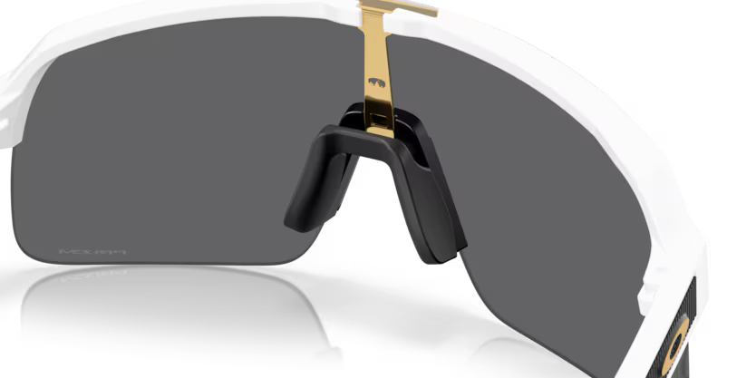 Oakley Sutro Lite Matte White Prizm Black sunglasses, three-quarter interior view showing the white frame and nose pads.