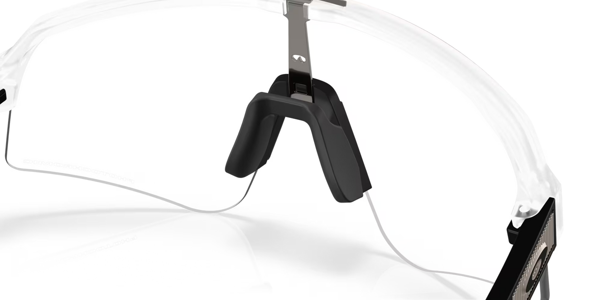 Oakley Sutro Lite Sweep Matte Clear Photochromic sunglasses, three-quarter interior view showing the translucent frame and nose pads.