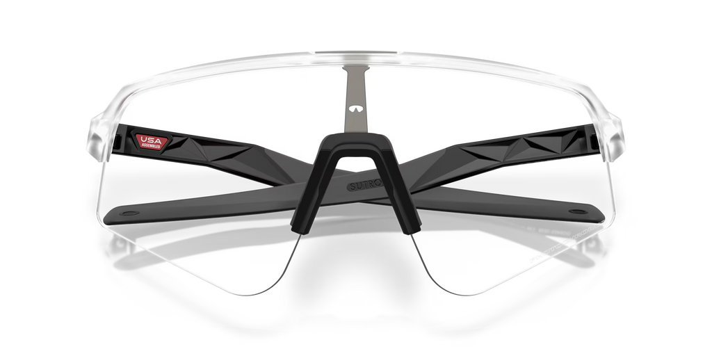 Oakley Sutro Lite Sweep Matte Clear Photochromic sports sunglasses, front view with crossed transparent temples visible through the lenses.